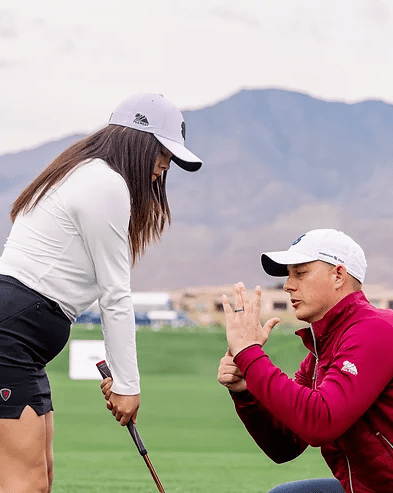 instructor teaching golfer