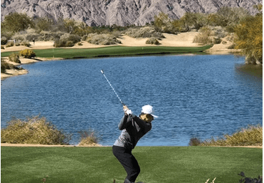 golfer swinging on course