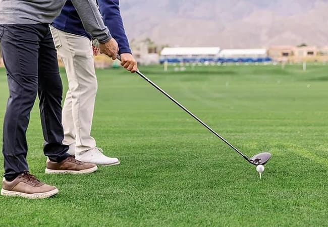 golfer and instructor on course