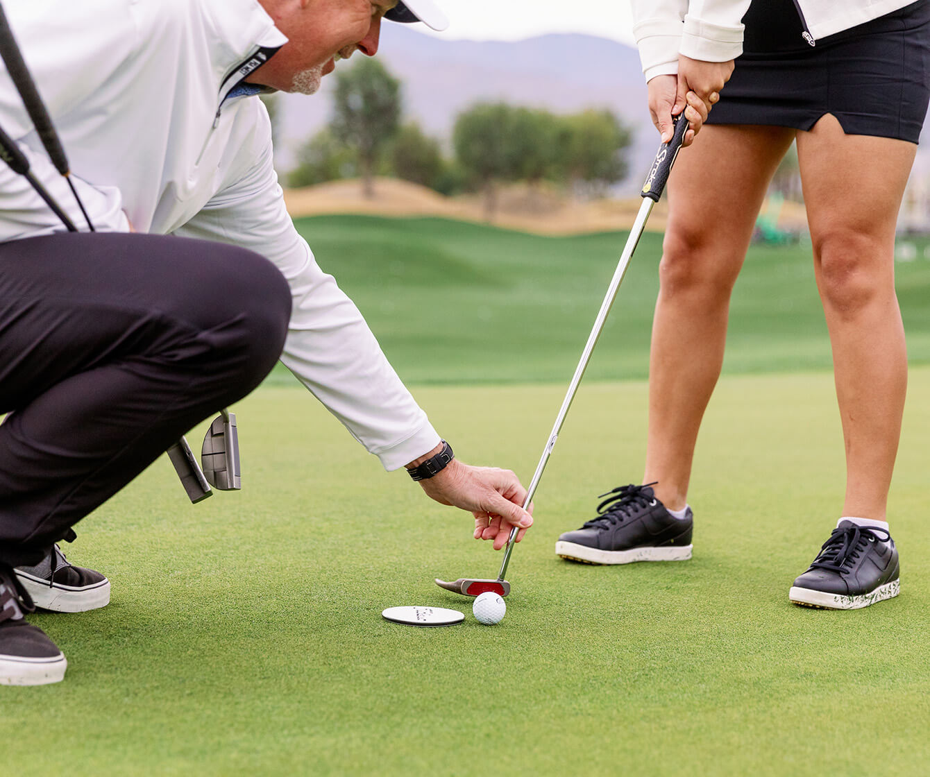 instructor teaching golfer