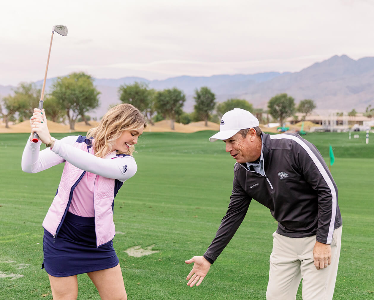 instructor teaching golfer